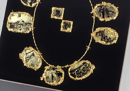 Necklace, 12 inches x 21 inches x 24 inches, mixed media, 1992; Global Africa Project, Museum of Arts & Design, NYC, 2010-11 ||| Necklace is a mixed media sculpture about the working conditions of South African gold miners during apartheid. Viewers are drawn to a beautifully presented ornate gold necklace. 