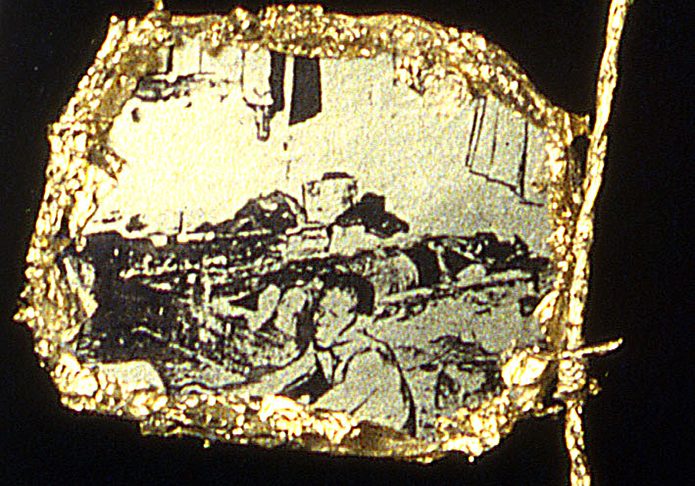 Necklace (detail-dormitory); Oval medallions show photographic images of the working conditions of miners in their dormitory and at work.