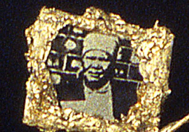 Necklace (detail-family)-Images of the family the miners left to work in the mines ||| Small squares show images of the family miners might be thinking about during the 11 months of the year they worked in the mines.